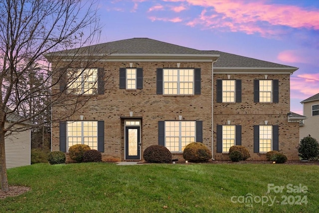 colonial inspired home with a yard