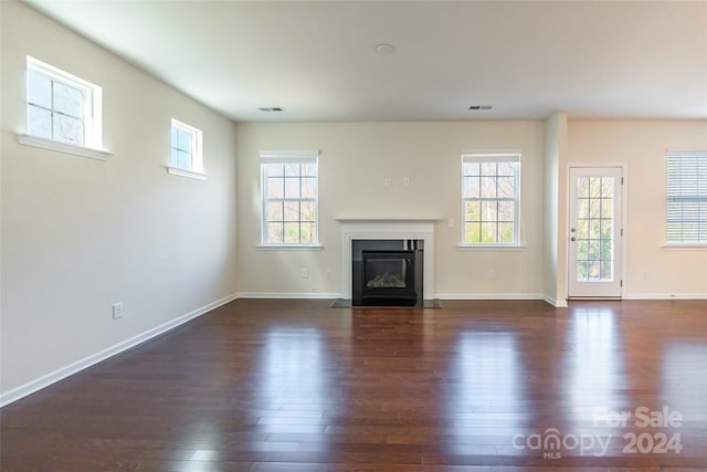 unfurnished living room featuring dark wood-type flooring