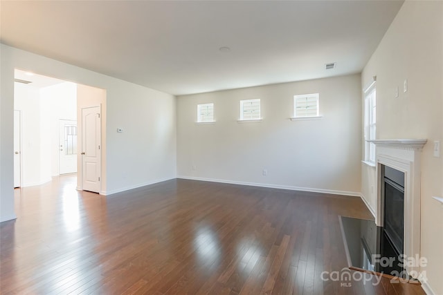 unfurnished living room featuring dark wood-type flooring