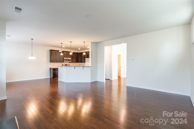 unfurnished living room featuring dark hardwood / wood-style flooring