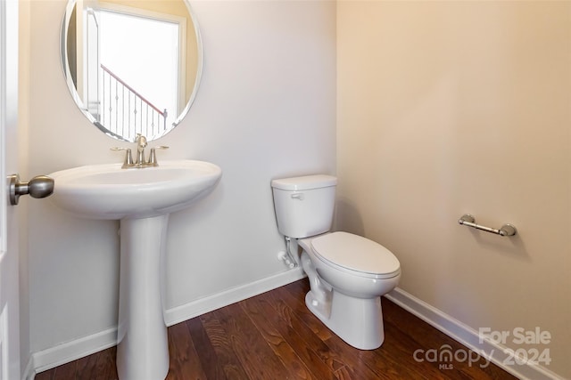 bathroom featuring sink, toilet, and hardwood / wood-style flooring