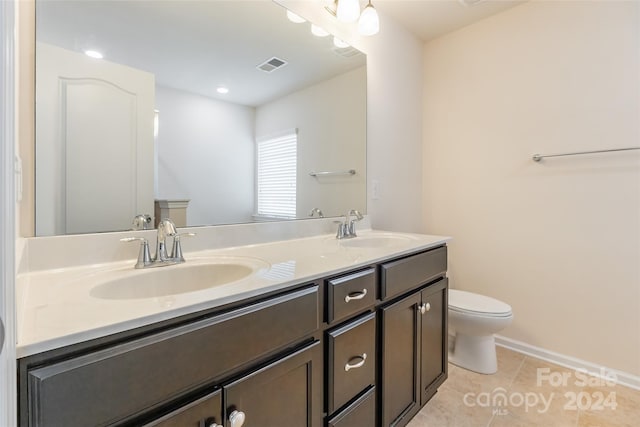 bathroom featuring tile patterned flooring, vanity, and toilet