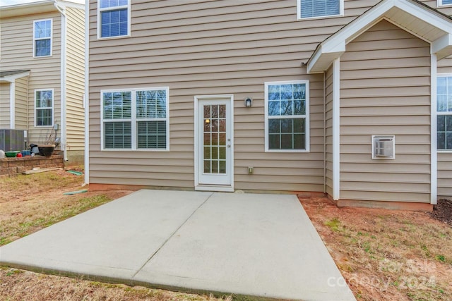 property entrance with a patio area and central AC unit