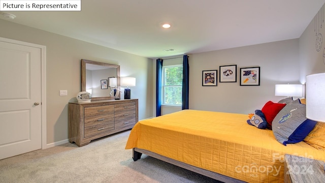 bedroom featuring light colored carpet