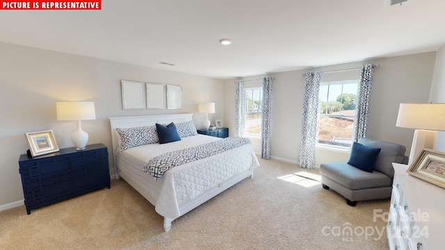 bedroom featuring light carpet