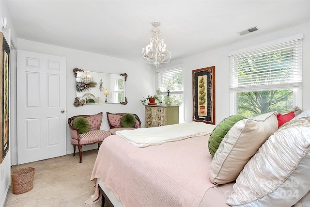 bedroom with light carpet and a chandelier