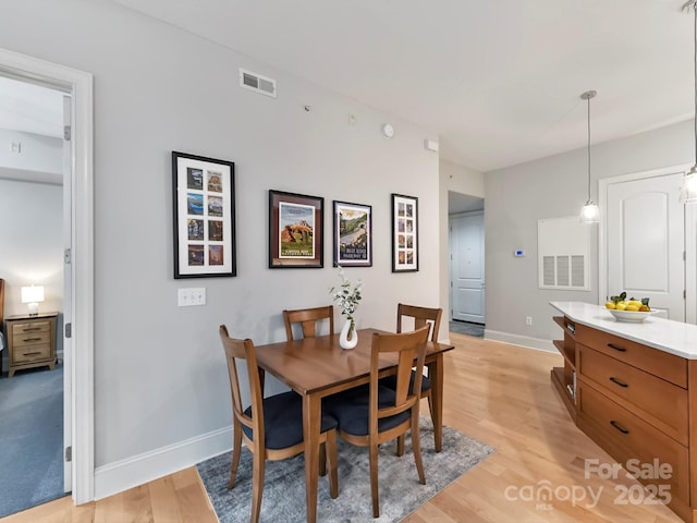 dining space with light hardwood / wood-style floors