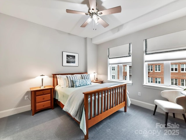 bedroom with ceiling fan and dark carpet