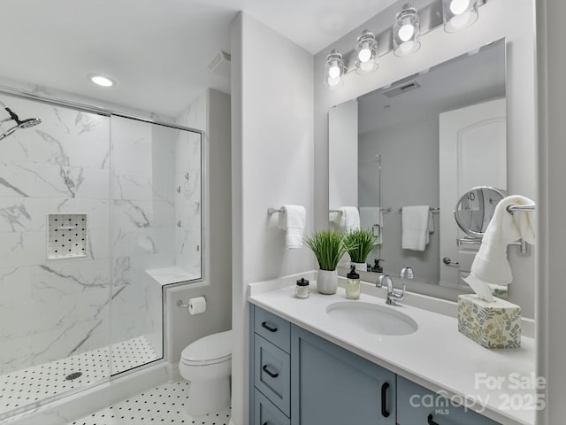 bathroom with vanity, toilet, and an enclosed shower