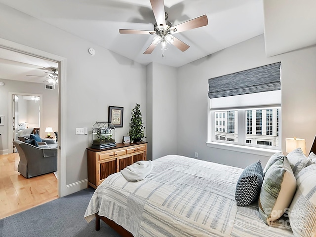 bedroom with hardwood / wood-style floors and ceiling fan