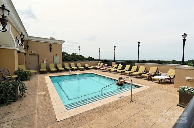 view of pool featuring a patio