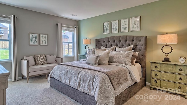 carpeted bedroom featuring multiple windows