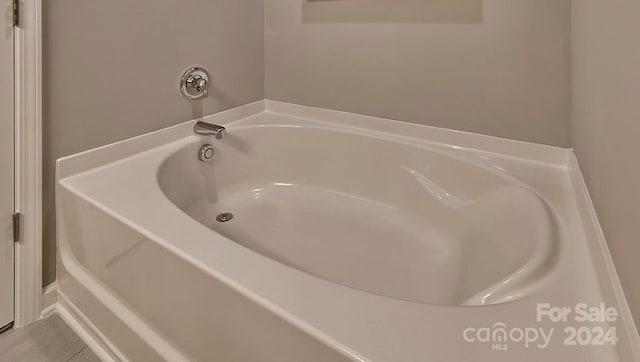 bathroom featuring tile patterned flooring and a bathtub