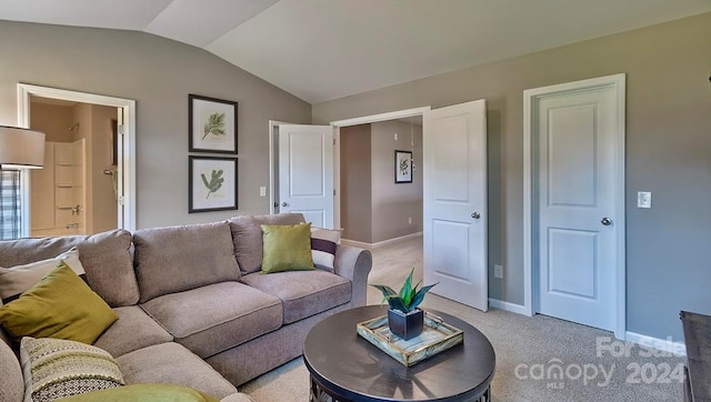 carpeted living room with lofted ceiling