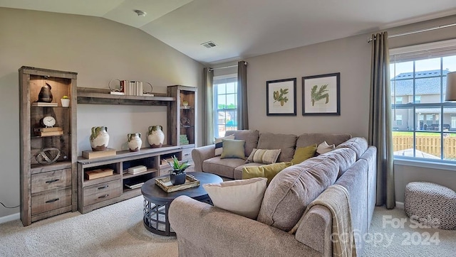 carpeted living room featuring a healthy amount of sunlight and lofted ceiling