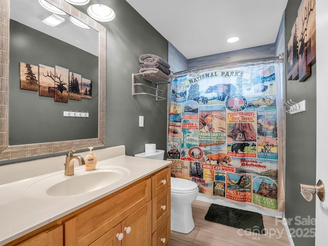 bathroom featuring a shower with curtain, vanity, and toilet