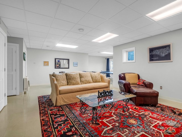 living room featuring a paneled ceiling