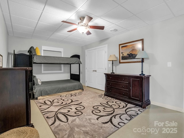 bedroom with a paneled ceiling and ceiling fan