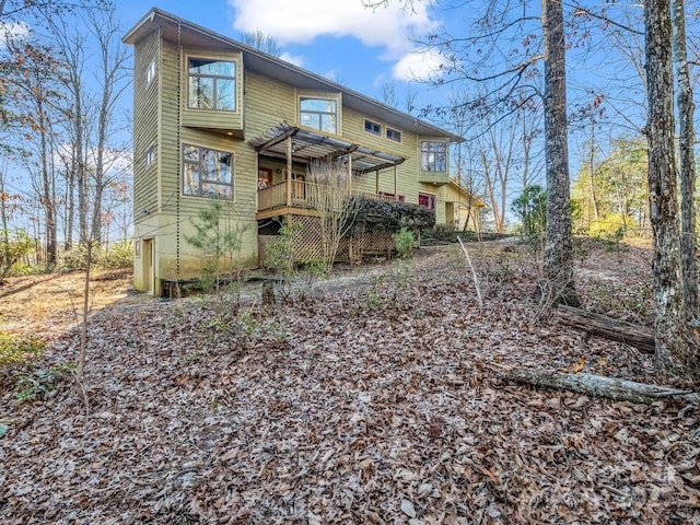 back of house featuring a wooden deck