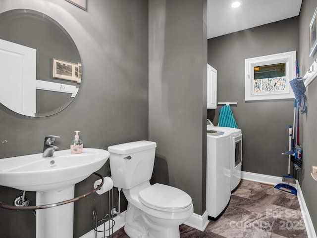 bathroom with washer and dryer and toilet