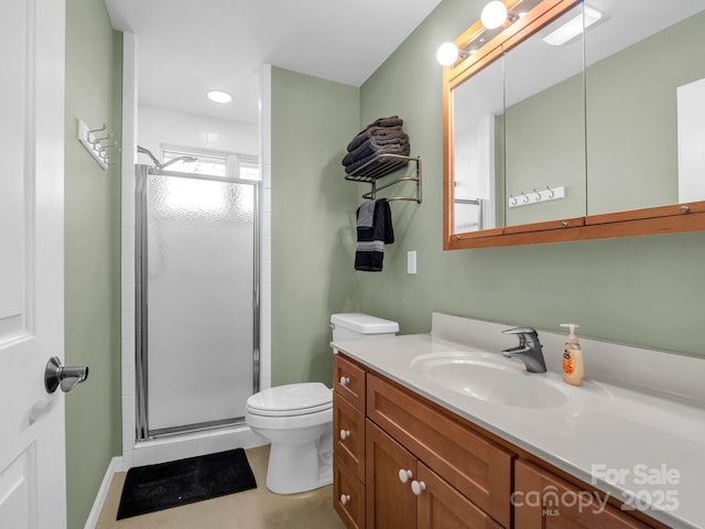 bathroom with vanity, an enclosed shower, and toilet