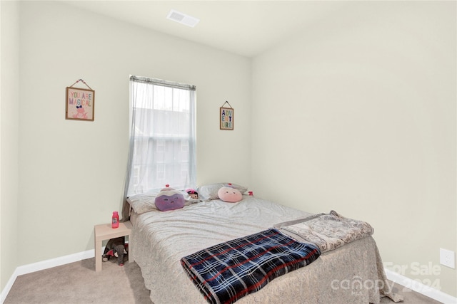 bedroom featuring light carpet