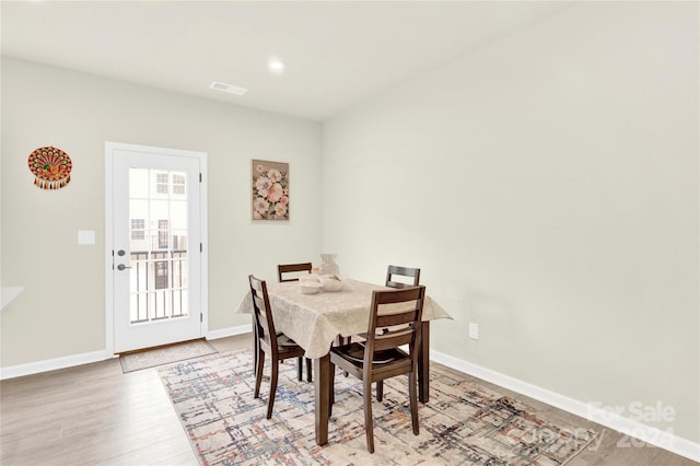 dining space with light hardwood / wood-style floors