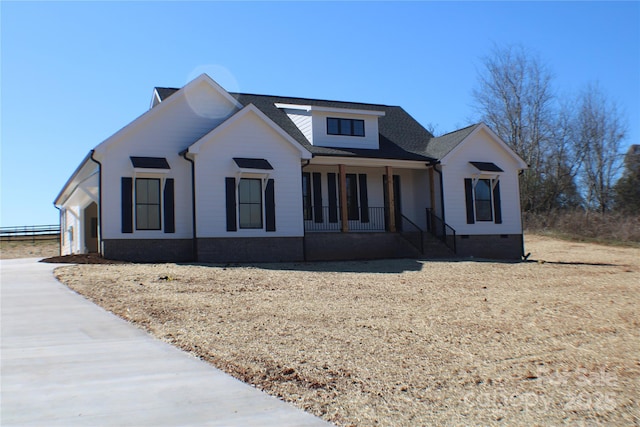 modern farmhouse featuring crawl space and covered porch