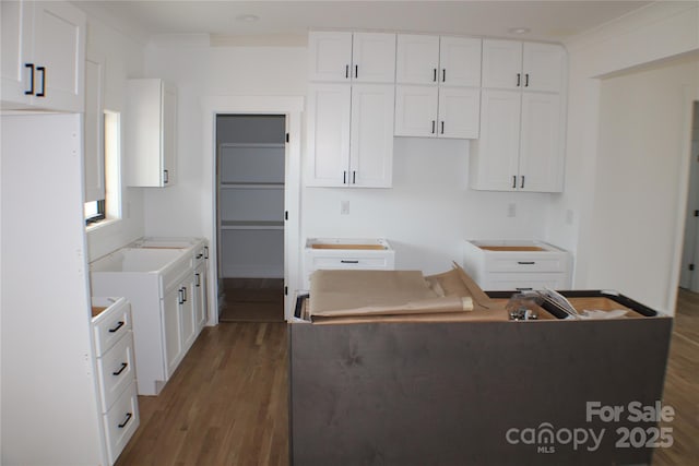 kitchen featuring a center island, white cabinetry, and wood finished floors