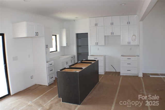 kitchen featuring a kitchen island and white cabinetry