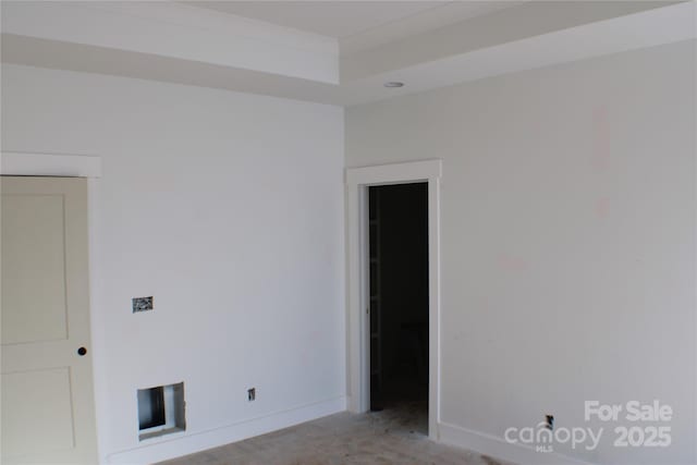 empty room featuring baseboards and light colored carpet