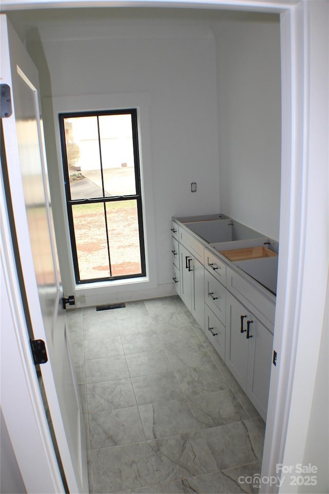 bathroom with marble finish floor and visible vents