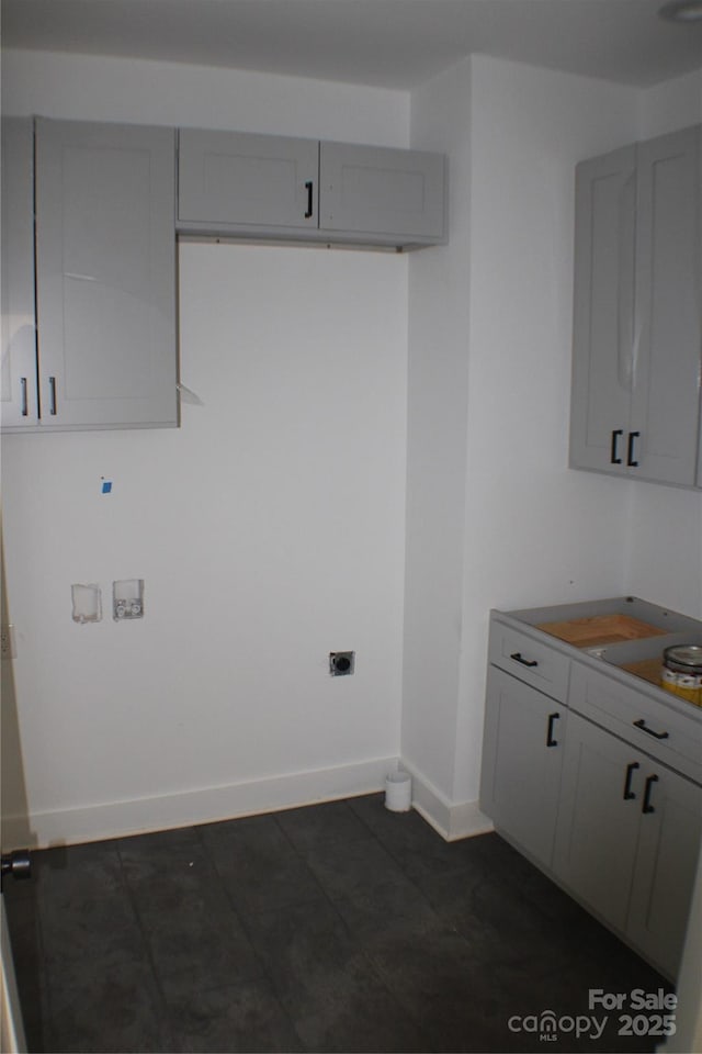 laundry room featuring baseboards