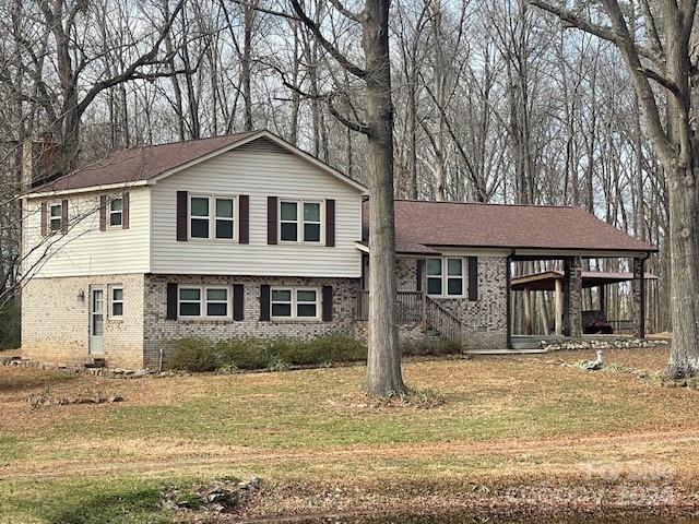 tri-level home with a front lawn