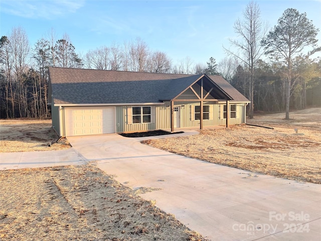 single story home featuring a porch and a garage