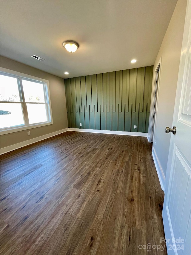 unfurnished room featuring dark wood-type flooring