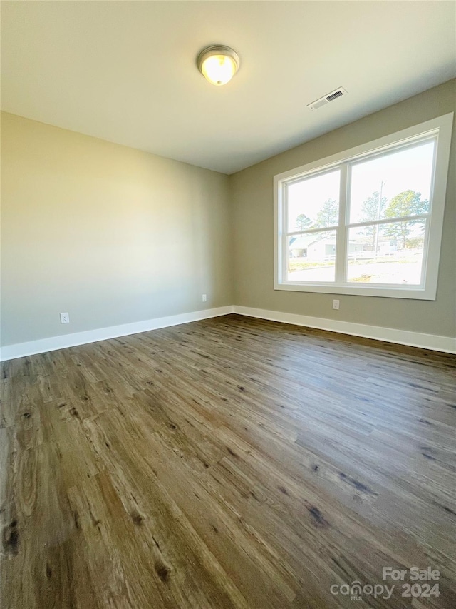 spare room with dark hardwood / wood-style flooring