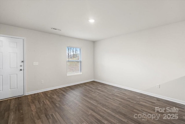 spare room featuring dark hardwood / wood-style floors