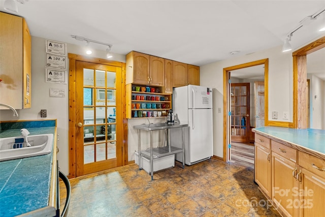 kitchen featuring white fridge, french doors, and sink