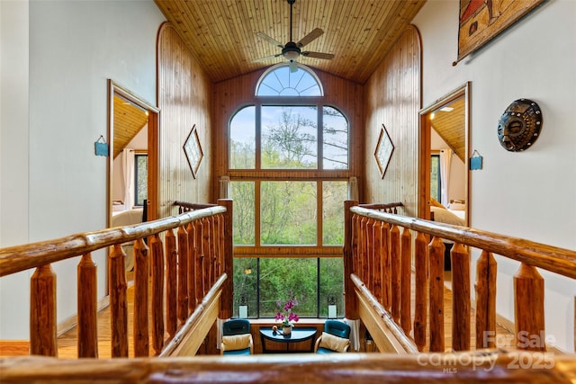 interior space featuring high vaulted ceiling, a wealth of natural light, wooden walls, and wooden ceiling