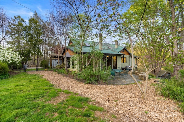 exterior space with a front yard and a patio