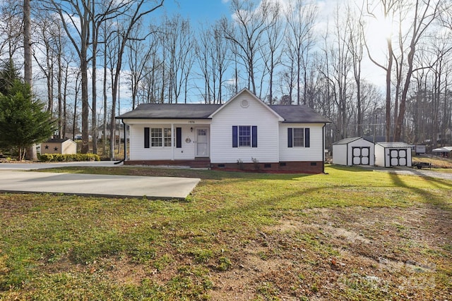 view of front of house with a front yard, a storage unit, and covered porch