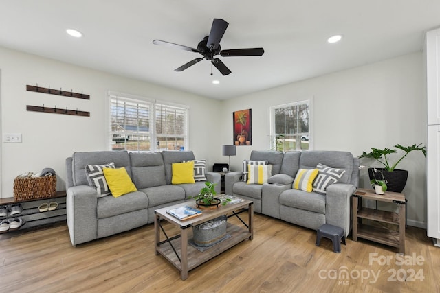 living room featuring light hardwood / wood-style flooring and ceiling fan