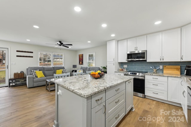 kitchen featuring white cabinetry, stainless steel appliances, and light hardwood / wood-style floors