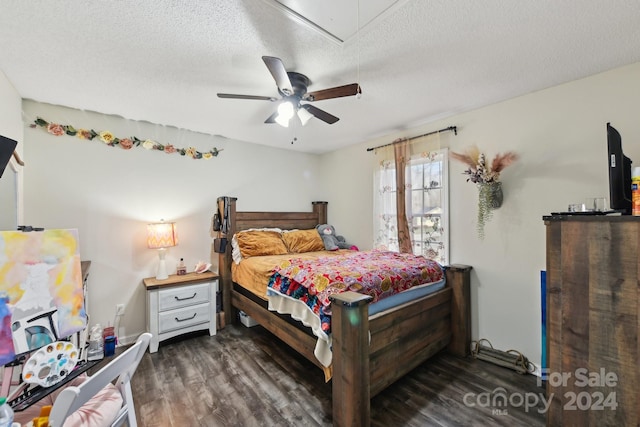 bedroom with ceiling fan, dark hardwood / wood-style floors, and a textured ceiling