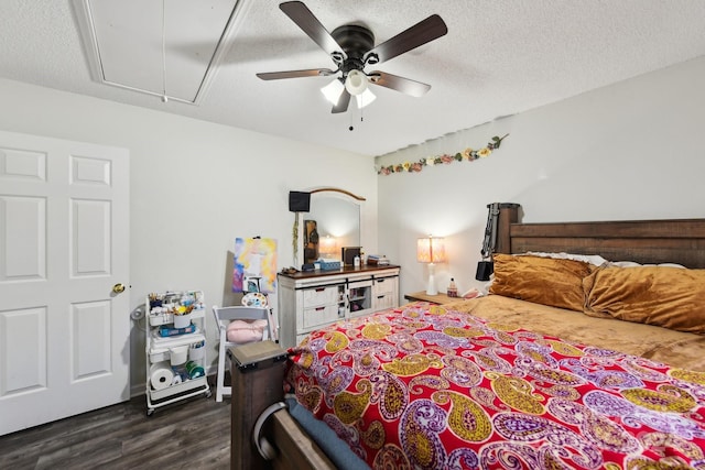 bedroom featuring a textured ceiling, ceiling fan, and dark wood-type flooring