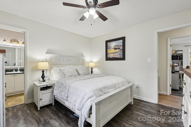 bedroom featuring a textured ceiling, connected bathroom, dark hardwood / wood-style floors, and ceiling fan