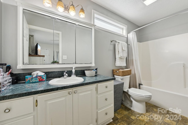 full bathroom featuring vanity, toilet, shower / bath combo with shower curtain, and a textured ceiling