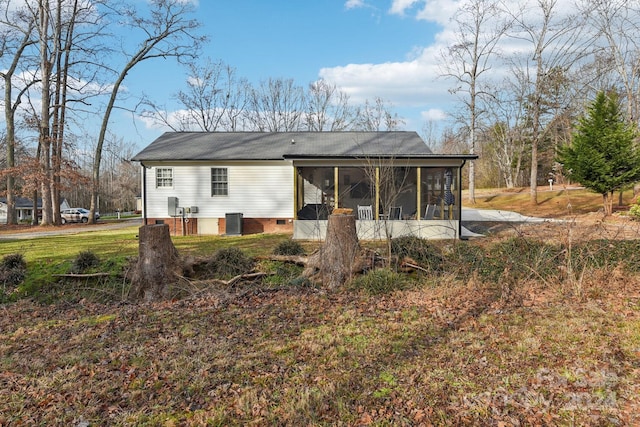 back of house featuring a sunroom and cooling unit