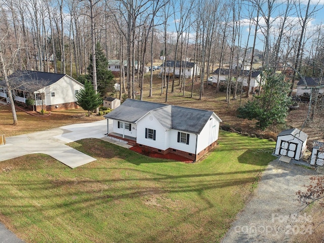 exterior space featuring a front yard and a storage shed